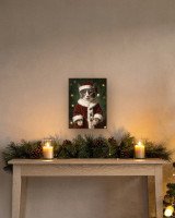 Portrait Le Père Noël sur toile 30 × 40 cm, accrochée au-dessus d’un meuble (photomontage, échelle indicative)